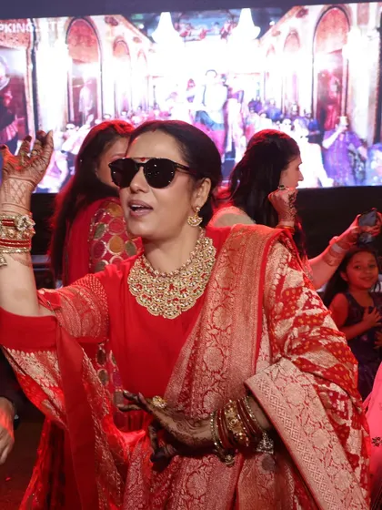 A moment of pure joy. Pooja Malik celebrates at her son's wedding, her handcrafted jewelry shining as brightly as her smile. This is what it means to wear pieces that feel truly special.