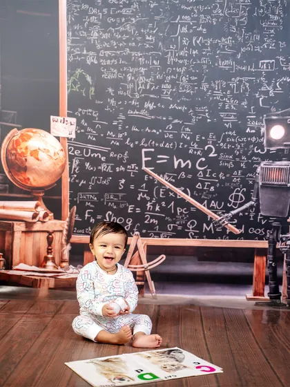 Assignments pending, cuteness submitted. The "Little Scholar" theme, with its chalkboard of equations and globe, is a fun way to picture your little genius at work.
