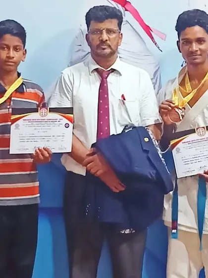Posing with my students and our medals after a challenging but successful state-level tournament. We always support each other as a team.