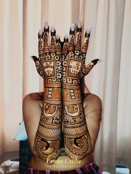 A heavy bridal back-hand design for a bride from Pune, featuring intricate patterns and traditional symbols.