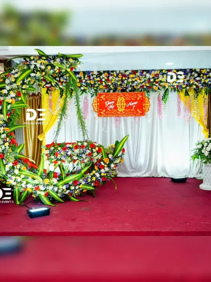 Another perspective of our crescent moon floral design for a naming ceremony. This setup combines a variety of colorful flowers with traditional yellow drapes for a vibrant celebration.