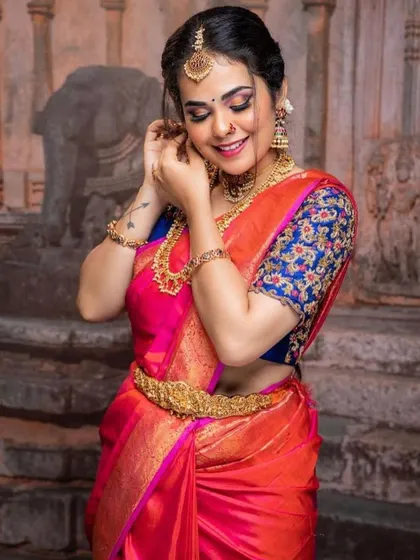 A beautiful example of how my temple jewelry complements a colorful silk saree. This set includes a choker and a mid-length necklace, along with a vaddanam, creating a balanced and elegant look for a bride.
