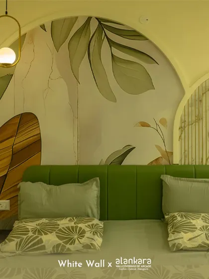 This bedroom design shows how a custom wallpaper can become the main feature. The large-scale botanical mural is framed by an architectural arch behind the bed, creating a stunning and artistic focal point that brings nature indoors.