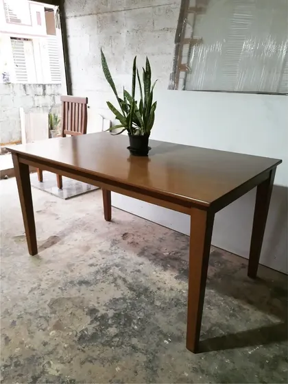 The dining table on its own, a sturdy and timeless piece of furniture.