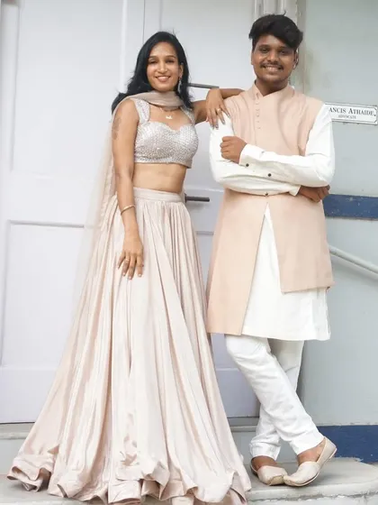 Get your his-and-her looks sorted with us. This simple yet elegant pairing features a flowing satin lehenga with a sequin blouse and a classic peach bandhgala jacket for him.