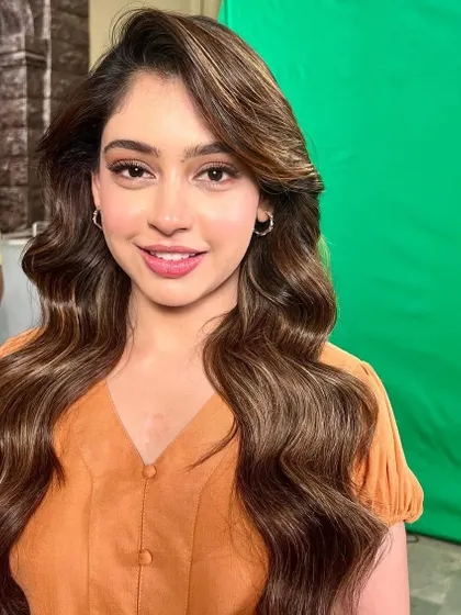 A happy, smiling shot of Niti, showcasing the natural-looking makeup that is perfect for any daytime event.