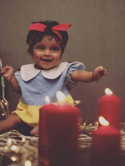 A little Snow White enjoying the Christmas season. The warm glow of the candles and fairy lights creates a magical and cozy atmosphere for this festive portrait.