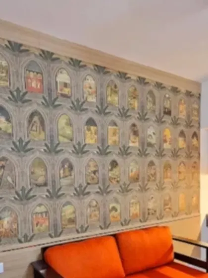 A unique wallpaper design featuring repeating arched windows (jharokhas), each containing a different miniature painting, creating a wall of stories.