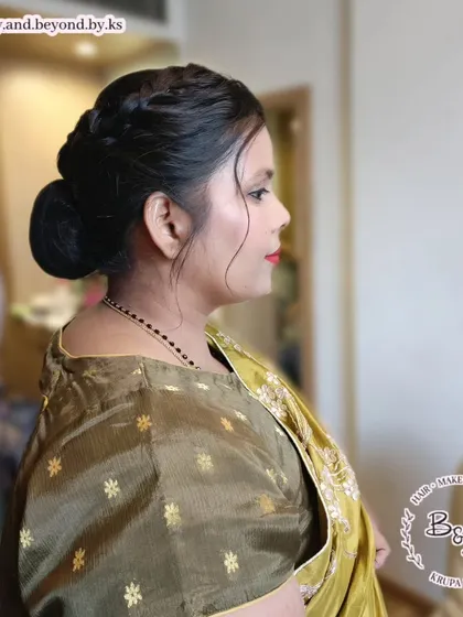 A side profile of the elegant side braid and low bun combination. This classic Indian wedding hairstyle is perfect for guests who want a polished and timeless updo.