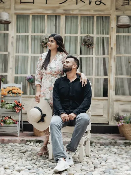 A playful pose using a chair and a hat as props. Incorporating simple props can make the shoot more interactive and fun, leading to more natural and expressive photos.