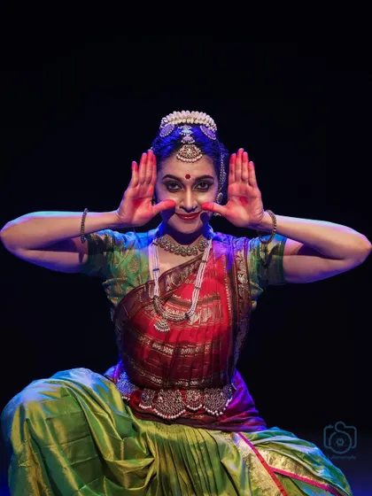 A close-up of the "deer" mudra, where the hands and face together evoke the imagery of the poetry being danced.