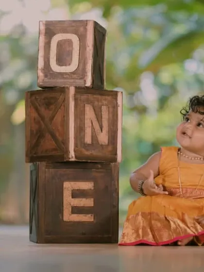 A simple and rustic first birthday theme. The stacked wooden "ONE" blocks are a versatile prop that works well with our outdoor-style flooring and natural light setups.