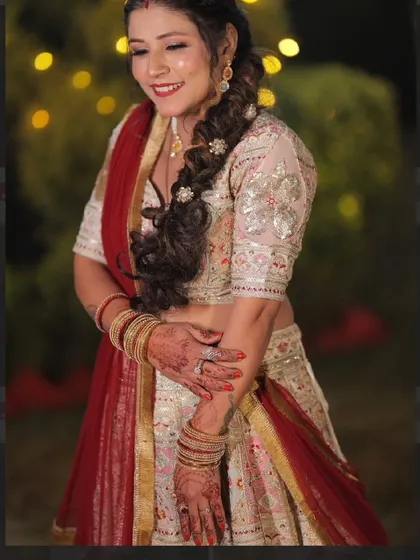 A close-up of my client in her beautiful white and red embroidered lehenga. The intricate details on the blouse and her happy smile say it all.
