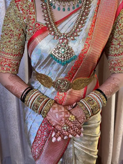 The complete bridal ensemble, showcasing the flawless saree drape, intricate jewellery, and beautiful henna. Every detail matters.