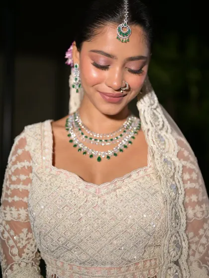 A close-up on the soft, shimmery eye makeup. The look is romantic and dreamy, perfect for her ethereal bridal style.