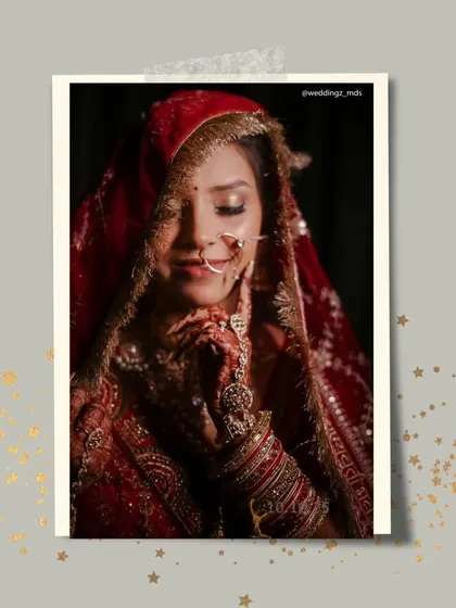 A shy, beautiful bride captured in a moment of quiet reflection, her face partially covered by her red bridal dupatta.