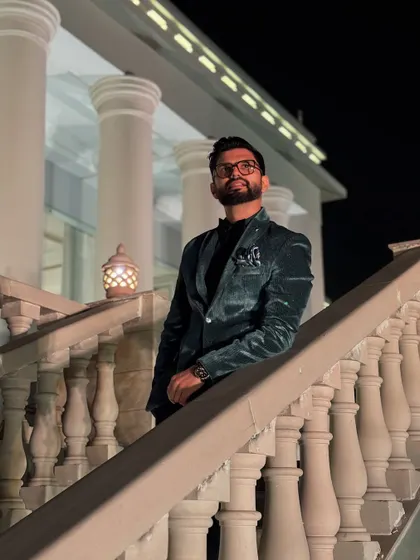 A different angle of the velvet blazer look, this time on a grand staircase. It adds a touch of royalty.