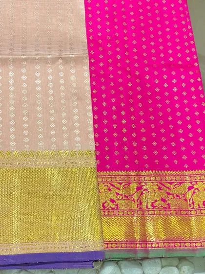 A beautiful contrast of rani pink and cream in these pure Kanjeevaram blouse pieces. The elephant motifs woven into the border are a classic design element.