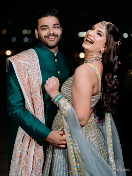 Pure happiness. This candid shot captures the couple's infectious laughter and the joyful spirit of their Mehendi function.