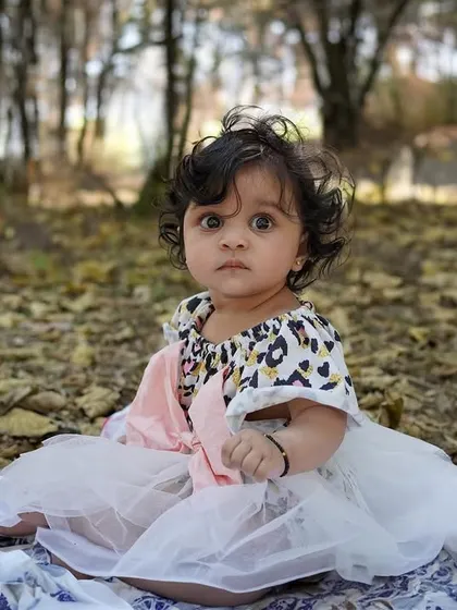 A baby girl's outdoor milestone session, complete with a curious cat who decided to join the photo. A truly unique and candid moment.