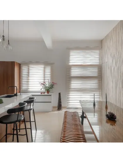 The open-plan dining and kitchen area in the Hemadri penthouse, featuring a fluted wall that adds texture and rhythm to the minimalist space.