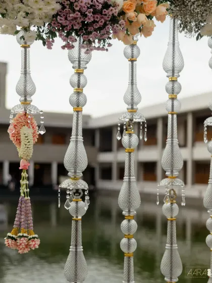 A close-up of the hanging decor, featuring intricate crystal tassels and delicate floral garlands. These details catch the light beautifully and add a sense of movement and grace to the overall design.