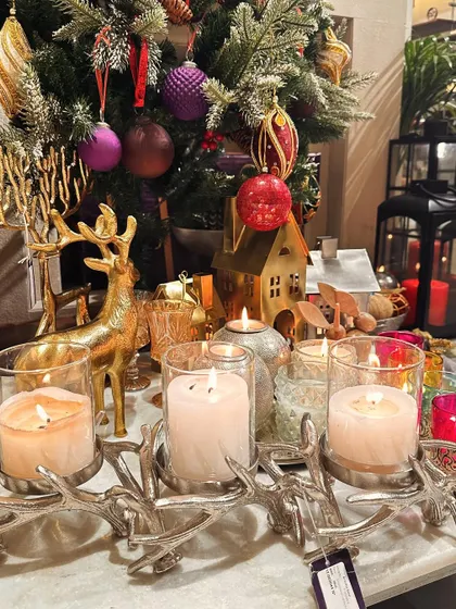 A festive tablescape featuring our silver branched candelabra, reindeer figurines, and other holiday accents, all set against a decorated Christmas tree.