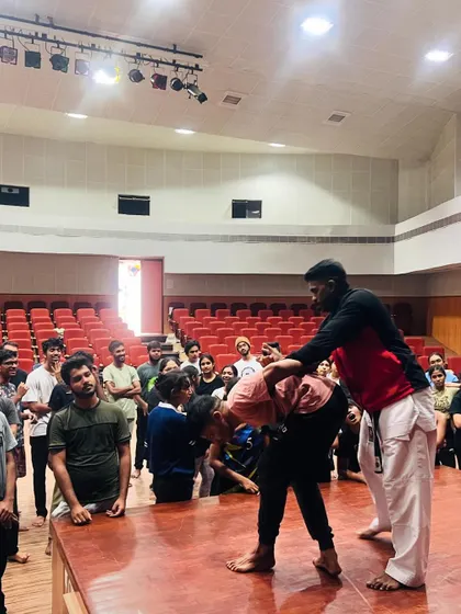 A demonstration of how to use leverage to control an opponent, a vital skill for women's self-defense.