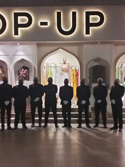 Our service team standing ready at an event for Pernia's Pop-Up Shop, a leader in luxury fashion. We understand the synergy between high fashion and fine food, providing catering that complements the elegance of the occasion.