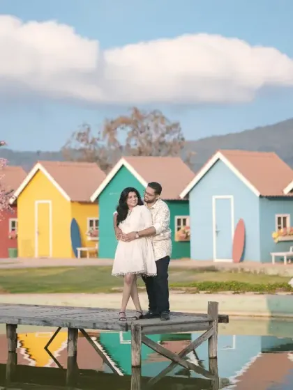 An anniversary shoot at 'Sets in the City', featuring a colorful, picturesque village set. This location offers a variety of vibrant backdrops for a fun and creative photoshoot.