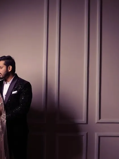 A beautifully composed shot of the engaged couple, using the wall panels to create leading lines and a sense of elegance.