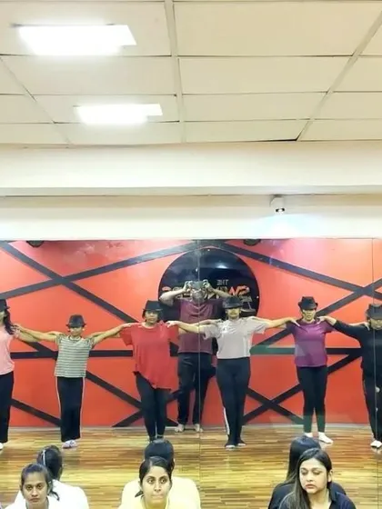 Students rehearsing a Broadway-style number for the "Inspirations" finale. The focus and teamwork are evident as they line up in formation.