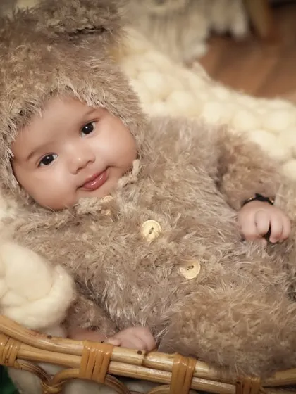 Awake and curious, this little bear looks right at the camera. We are skilled at capturing both sleeping and awake shots during our baby photoshoots.