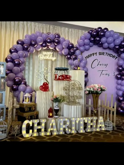 A lovely birthday setup in shades of purple for Charitha's third birthday. The double balloon arch adds depth and grandeur to the stage.