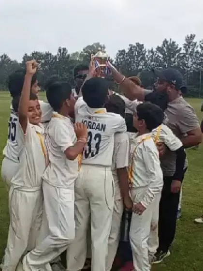 That winning feeling! The team lifts the championship trophy in a moment of pure celebration and unity after a hard-fought tournament victory.