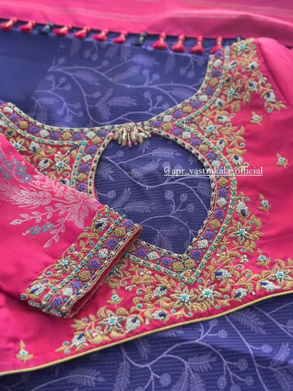 The back of the pink blouse, with a keyhole cutout.