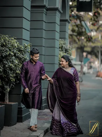 Capturing a candid moment as the couple walks down a classic Mumbai street. The architecture of the Kala Ghoda area provides a sophisticated urban backdrop for their traditional yet stylish outfits.