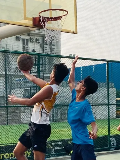 A close-up of a contested layup, highlighting the grit and determination we instill in our players.