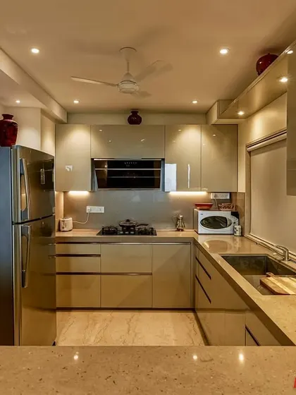 Another angle of the C-shaped acrylic kitchen, showing the ample counter space and integrated appliances.