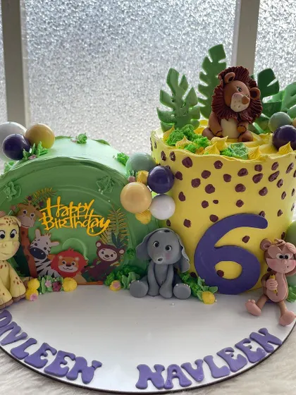 Another view of the jungle cake for twins, showing how the two halves come together to create one big scene. Perfect for celebrating two little ones at once.