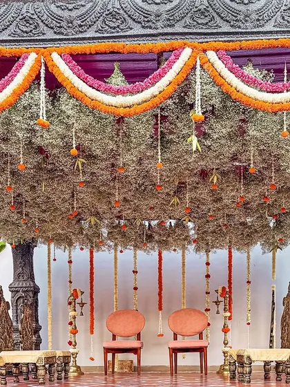 A bride's dream of a temple-style mandap, brought to life with stone-washed textures and a canopy of delicate, hanging florals. This sacred space was designed to feel as if it held generations of blessings.
