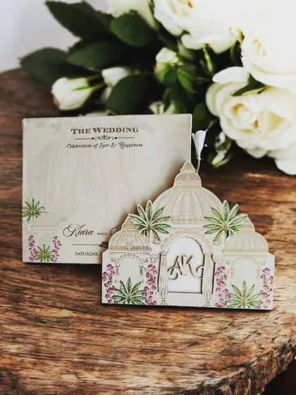 This dome-shaped laser-cut invitation is inspired by traditional Indian architecture, with pastel floral accents for a soft, romantic feel.