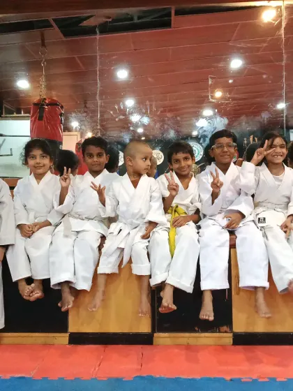 A candid moment with the Little Champs. Their smiles and peace signs show the fun and camaraderie we build alongside discipline.