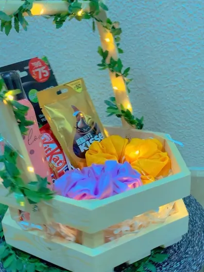 A close-up shot of the hexagon hamper, highlighting the vibrant colors of the scrunchies against the warm glow of the fairy lights.