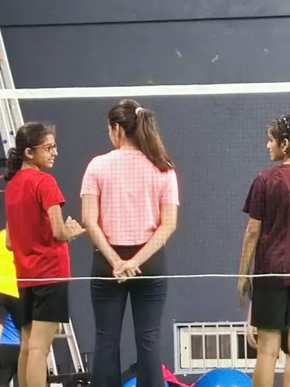 Connecting with our young athletes during a training session, offering encouragement and personalized feedback.
