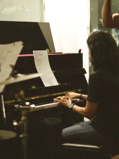A musician lost in the moment, playing the piano during one of our electrifying Artist Sessions. We love hosting these events to showcase incredible talent and share live music with our community.