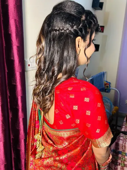 A soft and romantic half-up, half-down hairstyle with a braid. This is a great option for sangeet or engagement parties.