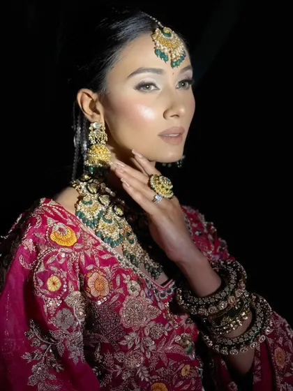 A side profile highlighting the flawless skin finish and the way the makeup catches the light. This is my signature dewy look, ensuring the bride glows from every angle throughout her wedding day.