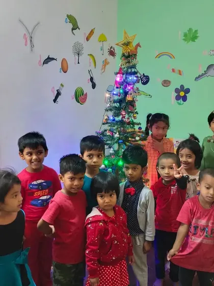 A group of friends posing by the Christmas tree. Celebrating these moments together creates happy memories for the children.