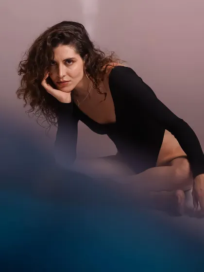 Another creative shot with a foreground blur, creating a sense of looking through something to glimpse a private, thoughtful moment.